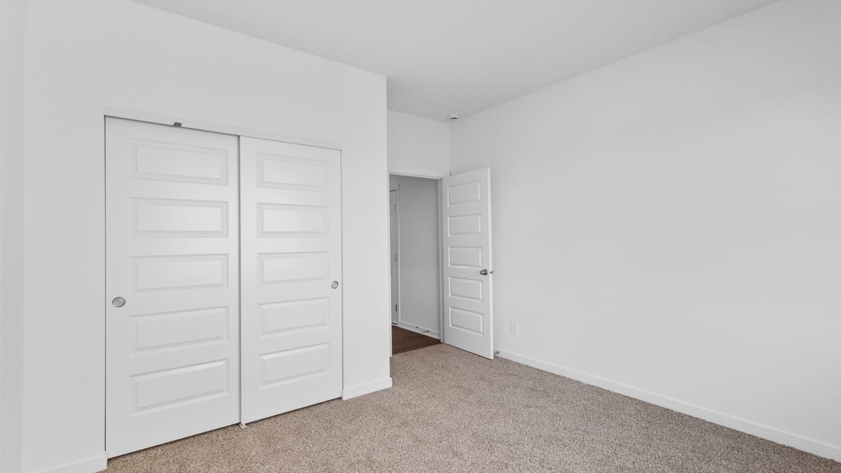Bedroom with carpet and closet.