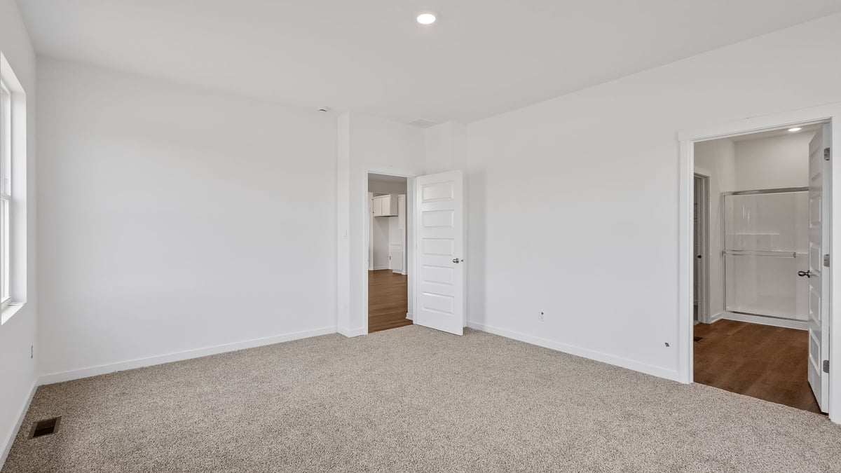 Room with bathroom and walk in closet.