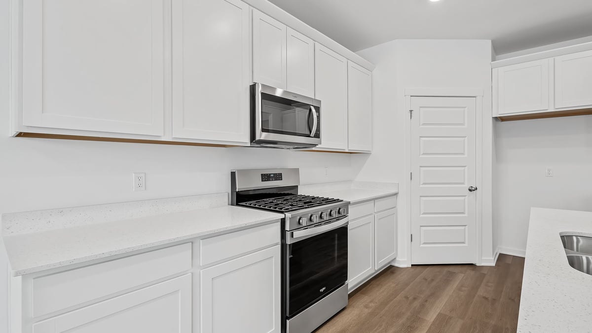 Kitchen with white cabinets and applicances.