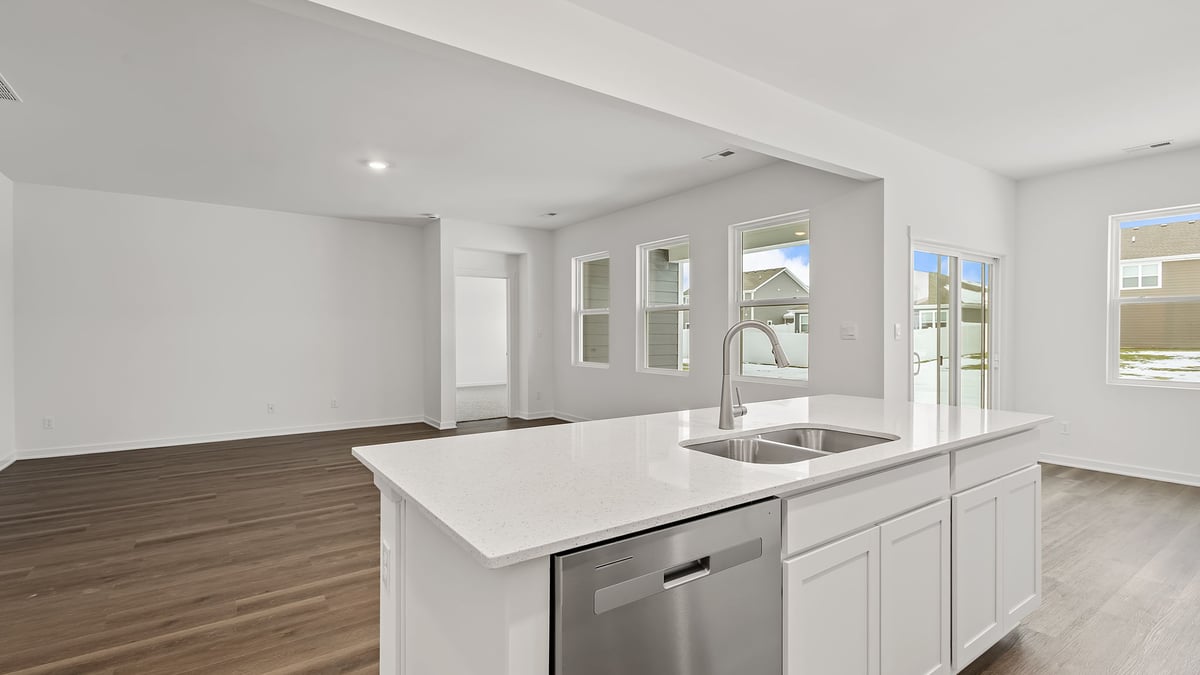 Kitchen island with quartz countertops and viewing of living room.