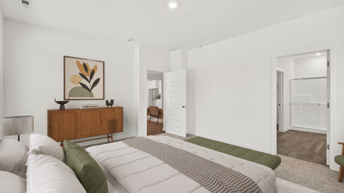 Primary bedroom with carpeted floors and great space.