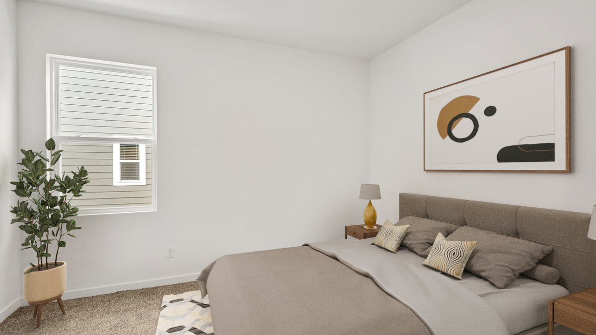 Bedroom with a side window and carpeted floors.