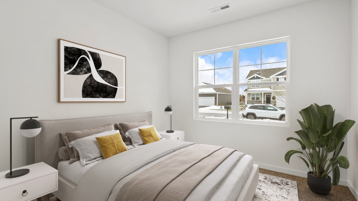 Bedroom with carpeted floors and a big window.