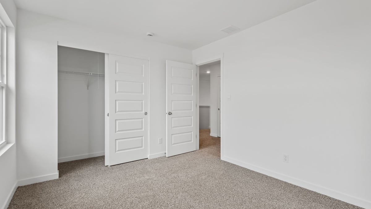 Bedroom with closet and carpet.
