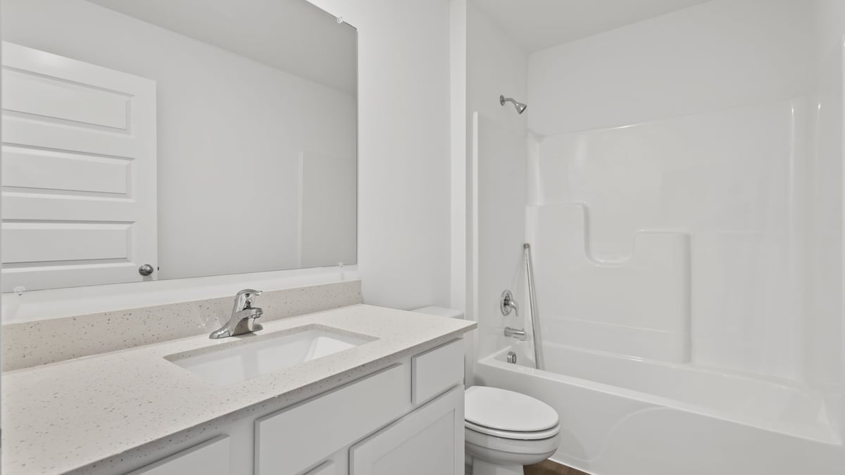 Dual vanity and sinks with a shower tub.