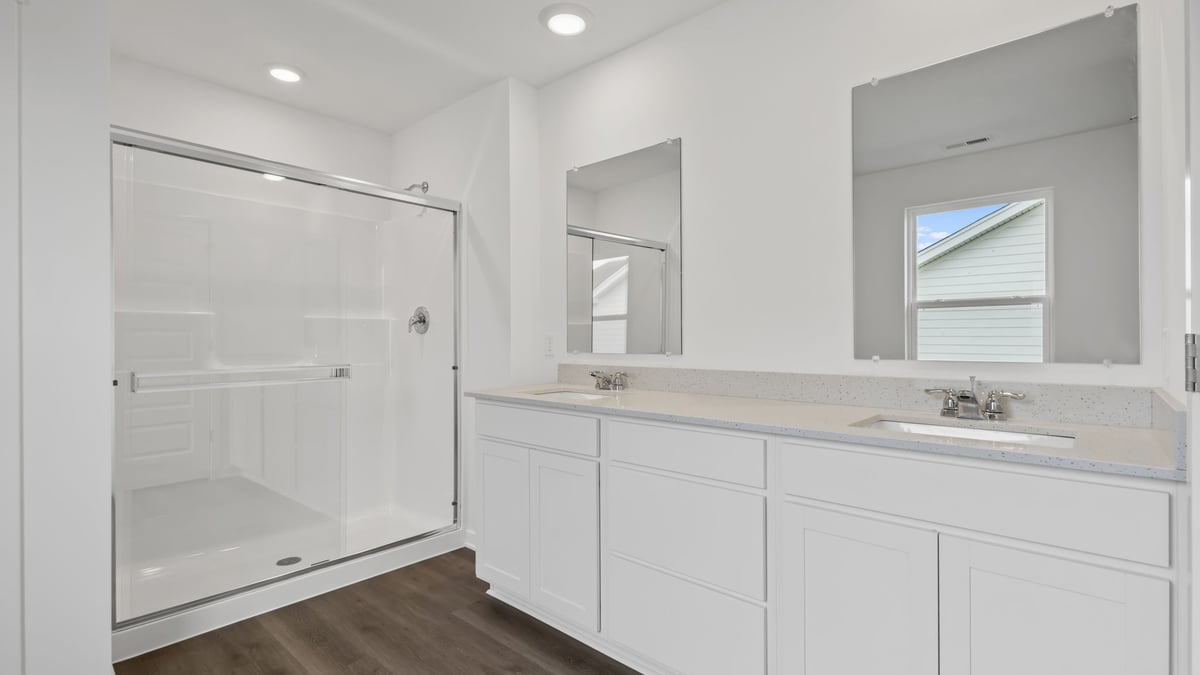 Bathroom with dual vanity sink and walk in shower.