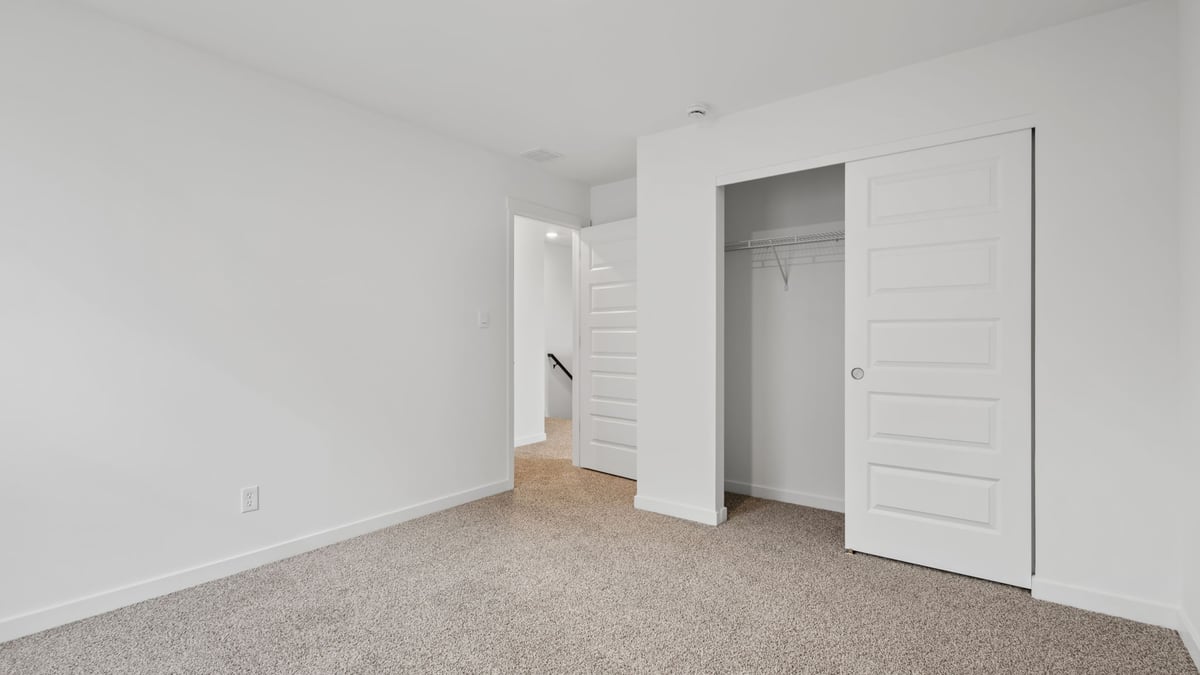 Bedroom with carpeted floor and closet.