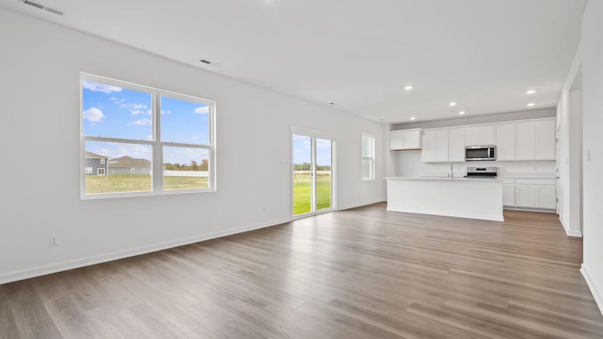 Open living room with windows and sliding back door.