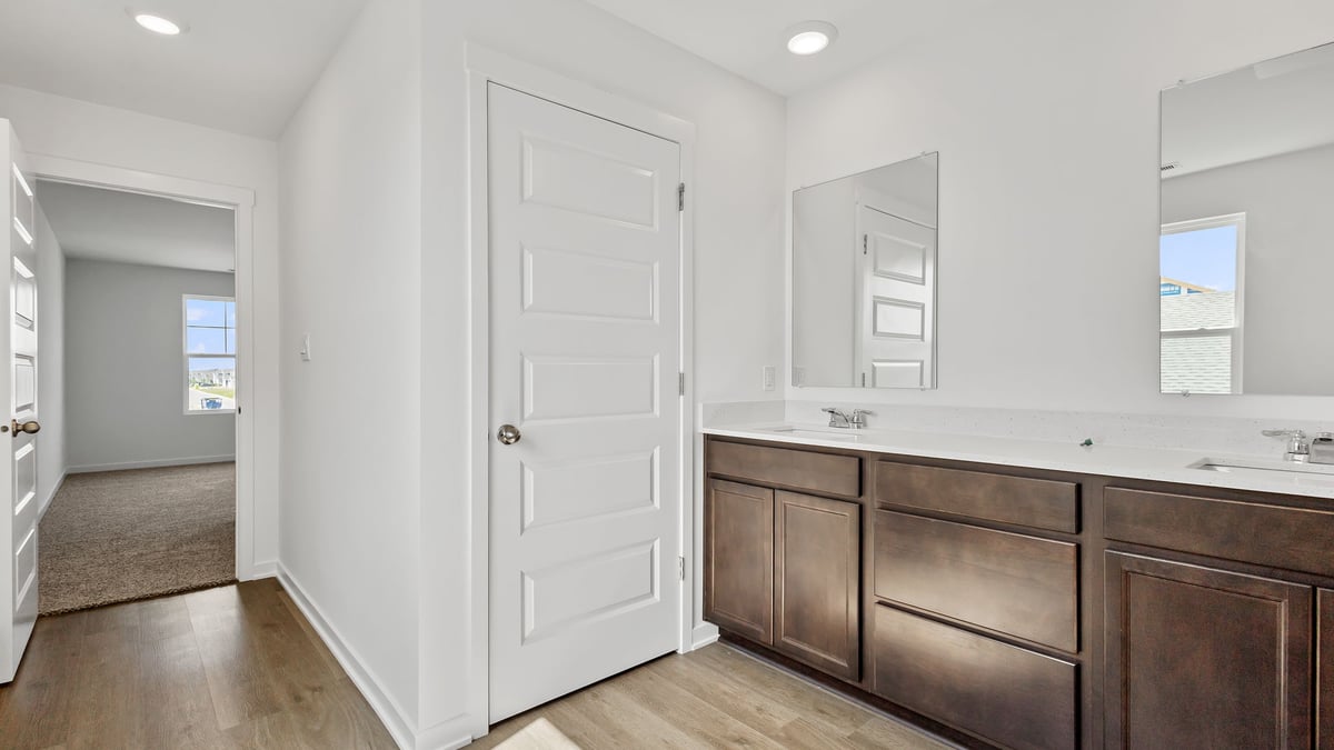 Primary bathroom with dual vanity sinks.
