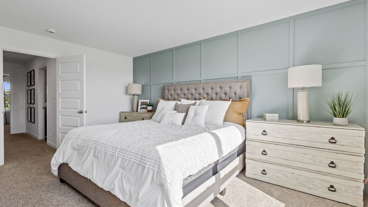 Primary bedroom with carpeted floors.