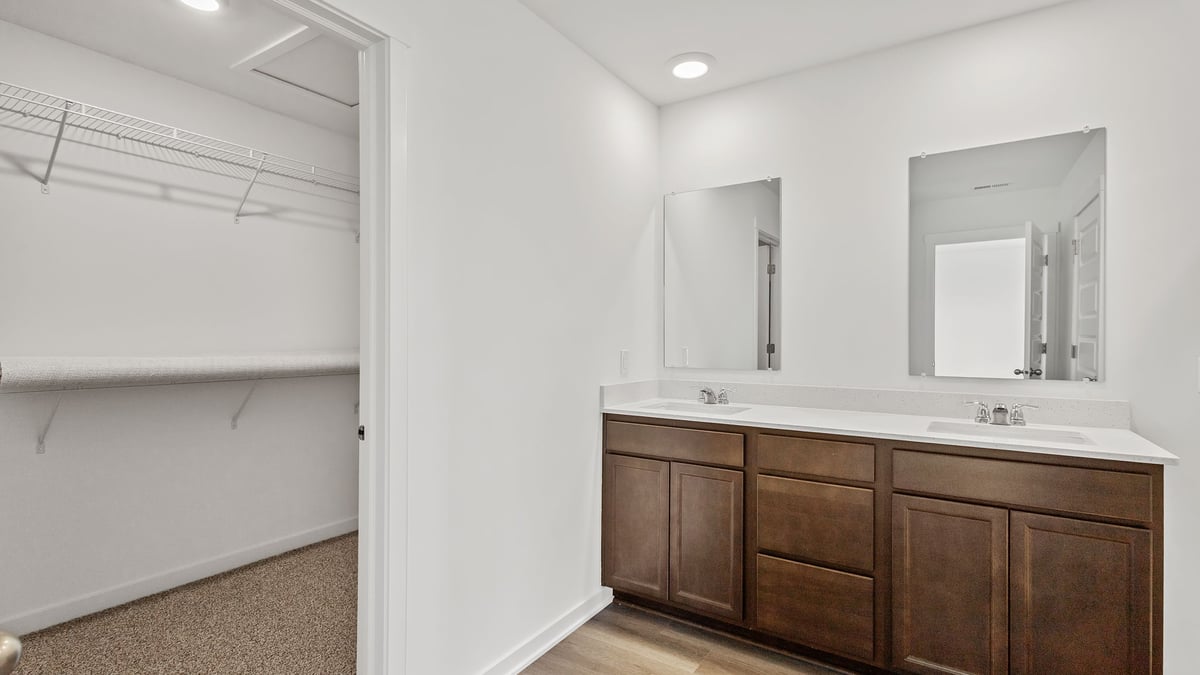 Primary bathroom with dual vanity sinks.