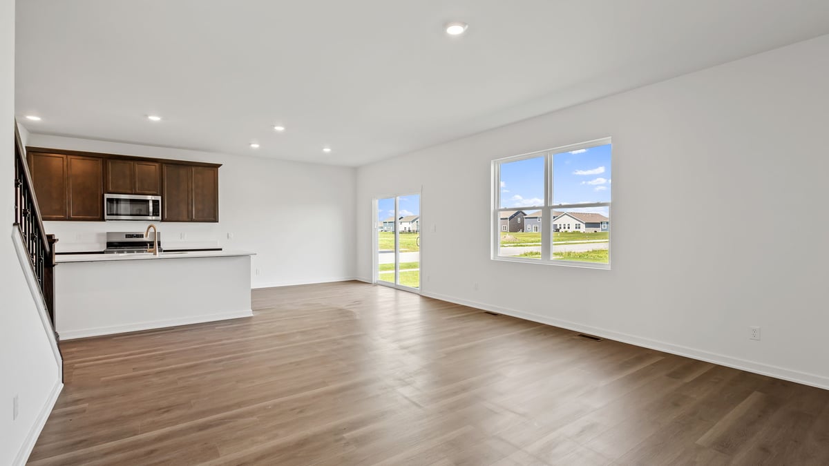 Living room area with great space and a big window and glass sliding doors.