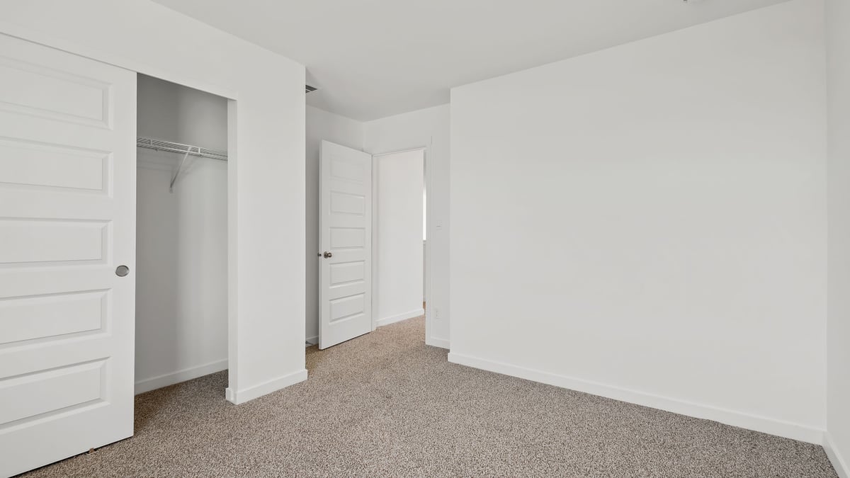 Bedroom with carpeted floors with a closet.