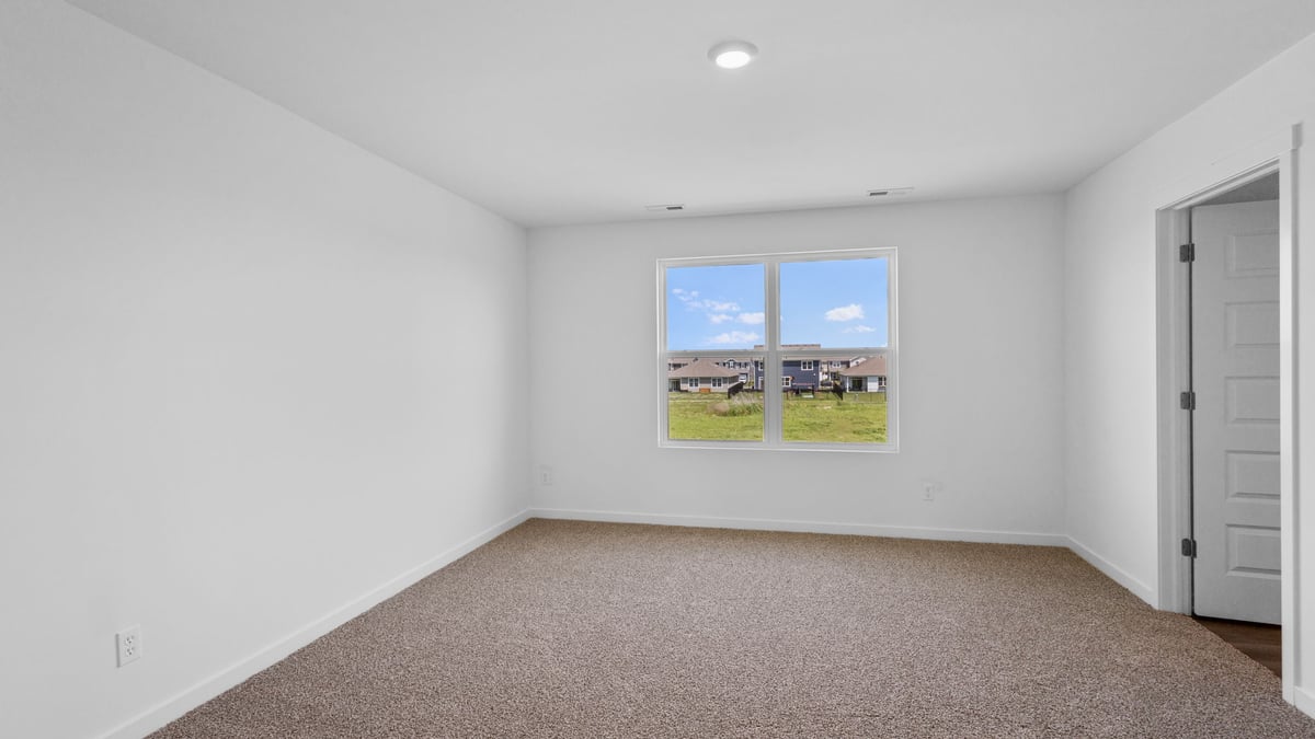 Primary bedroom with a big window and great space.
