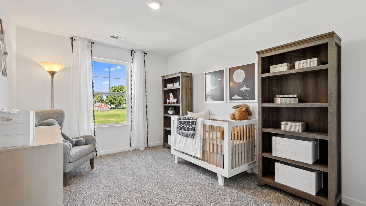 Bedroom with carpeted floors with a side window with carpeted floors.