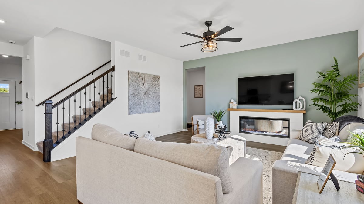 Living room area with great amounts of space with hard wood flooring.