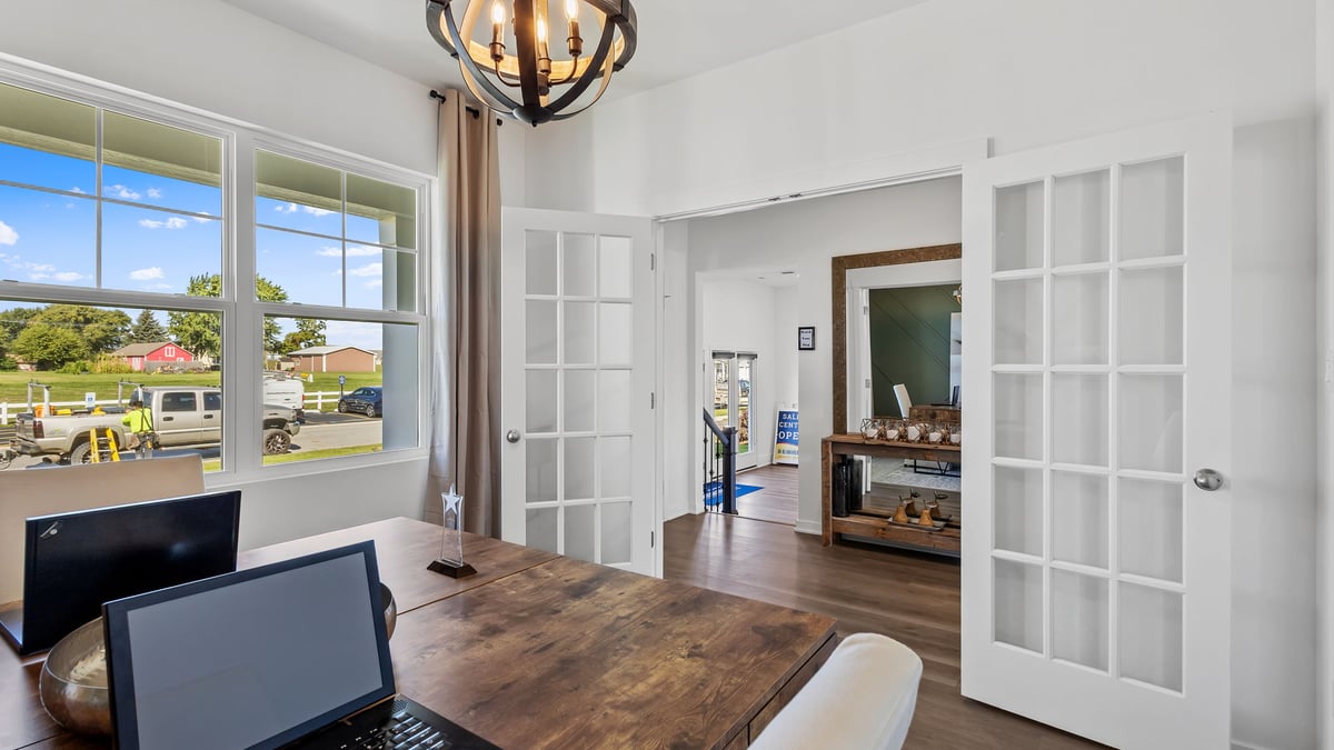 Front room with a  big window and french doors.
