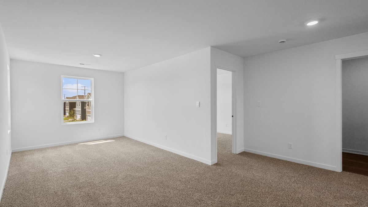 Loft area with a side window and carpet.