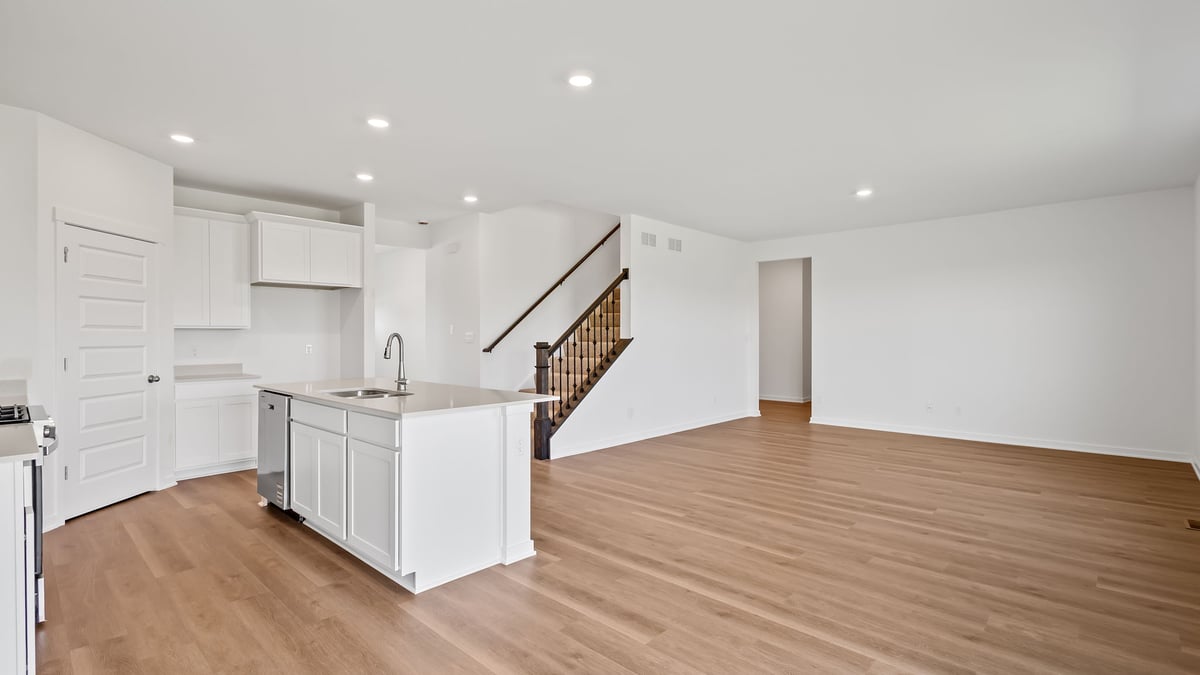 Kitchen and living room area with hard wood flooring.