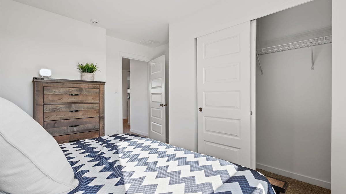 Bedroom with a closet and carpeted floors.