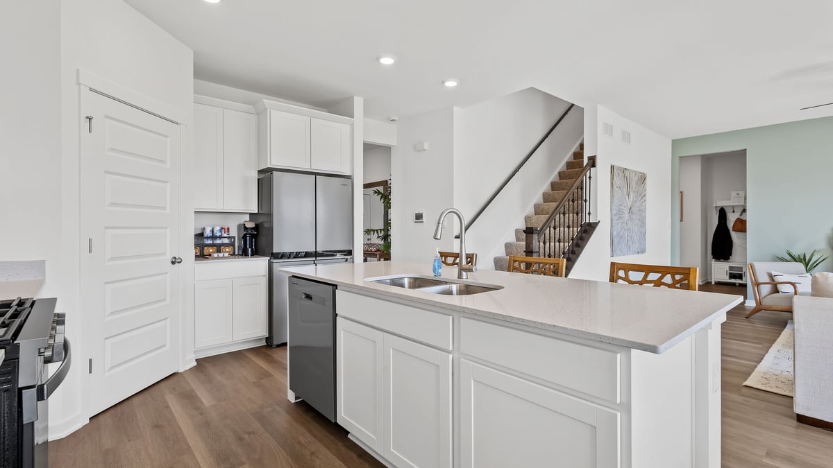 Kitchen with quartz countertops and viewing living room.