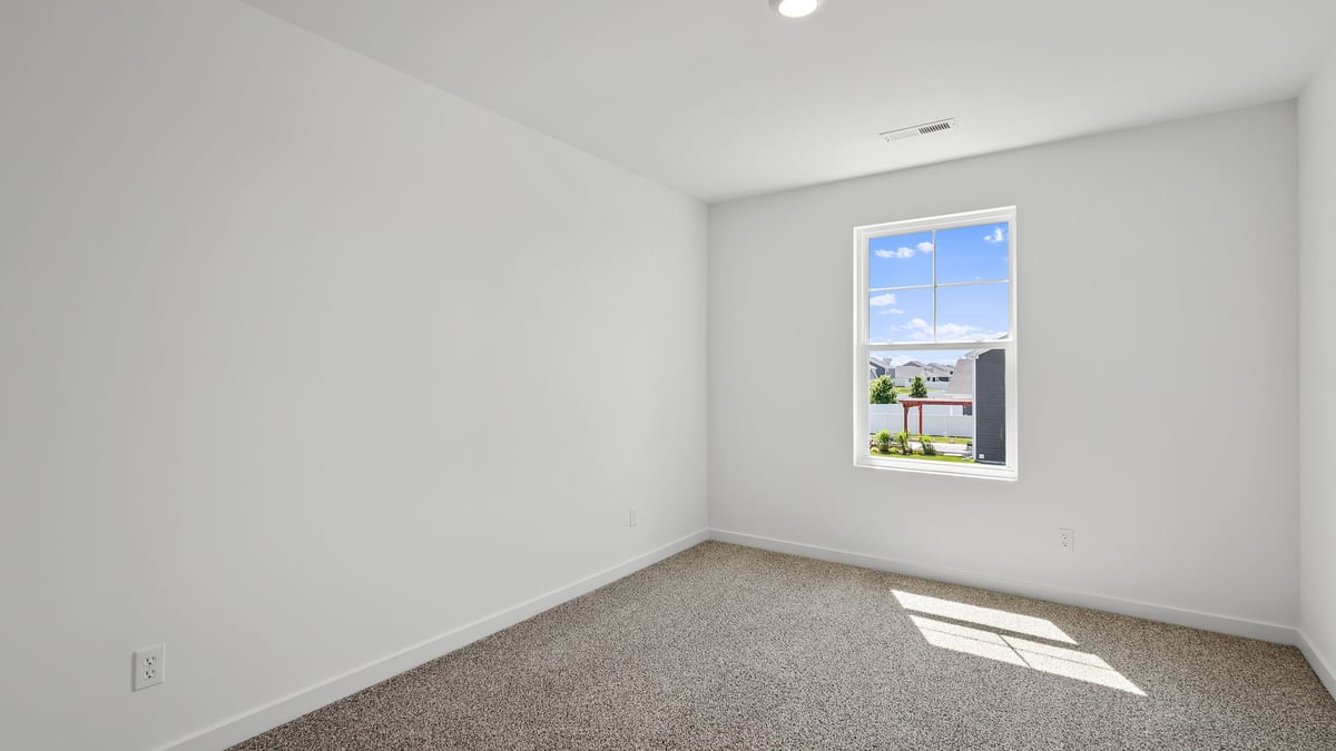 Bedroom with carpeted floors and a side window.