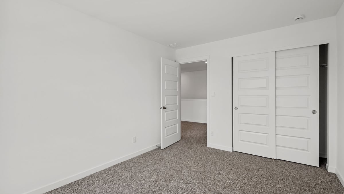 Bedroom with carpeted floors and closet.