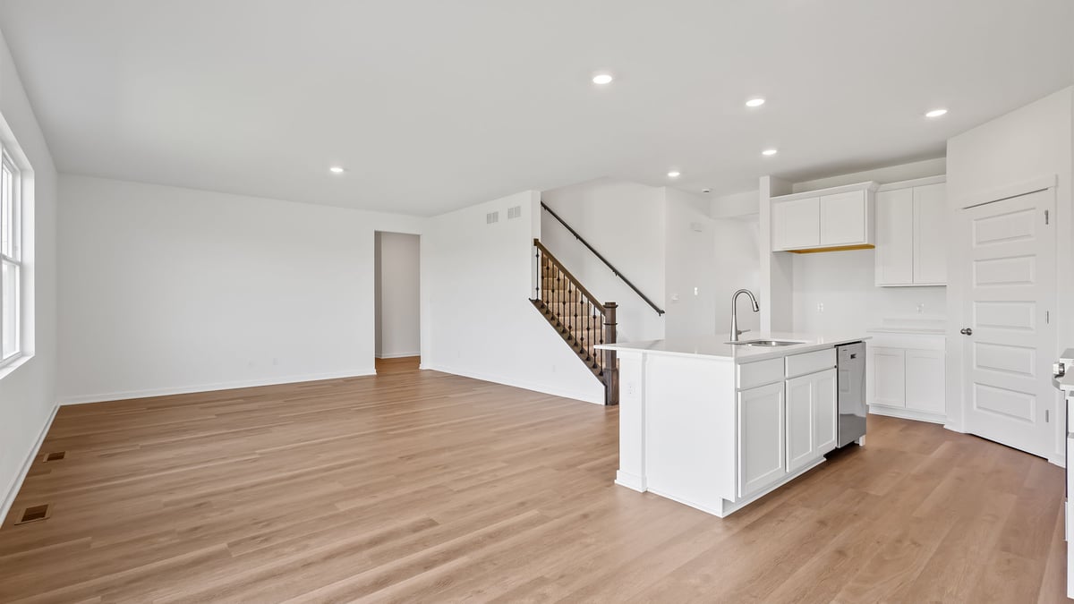 Living area with hard wood floors and the kitchen island.