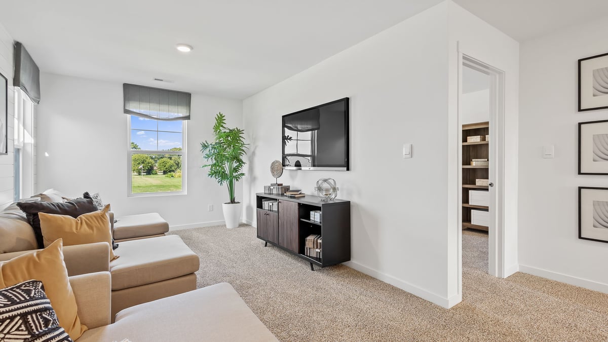 Loft space staged as a seating area with a side window.