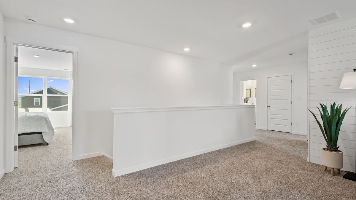 Upstairs loft area with carpeted floors.