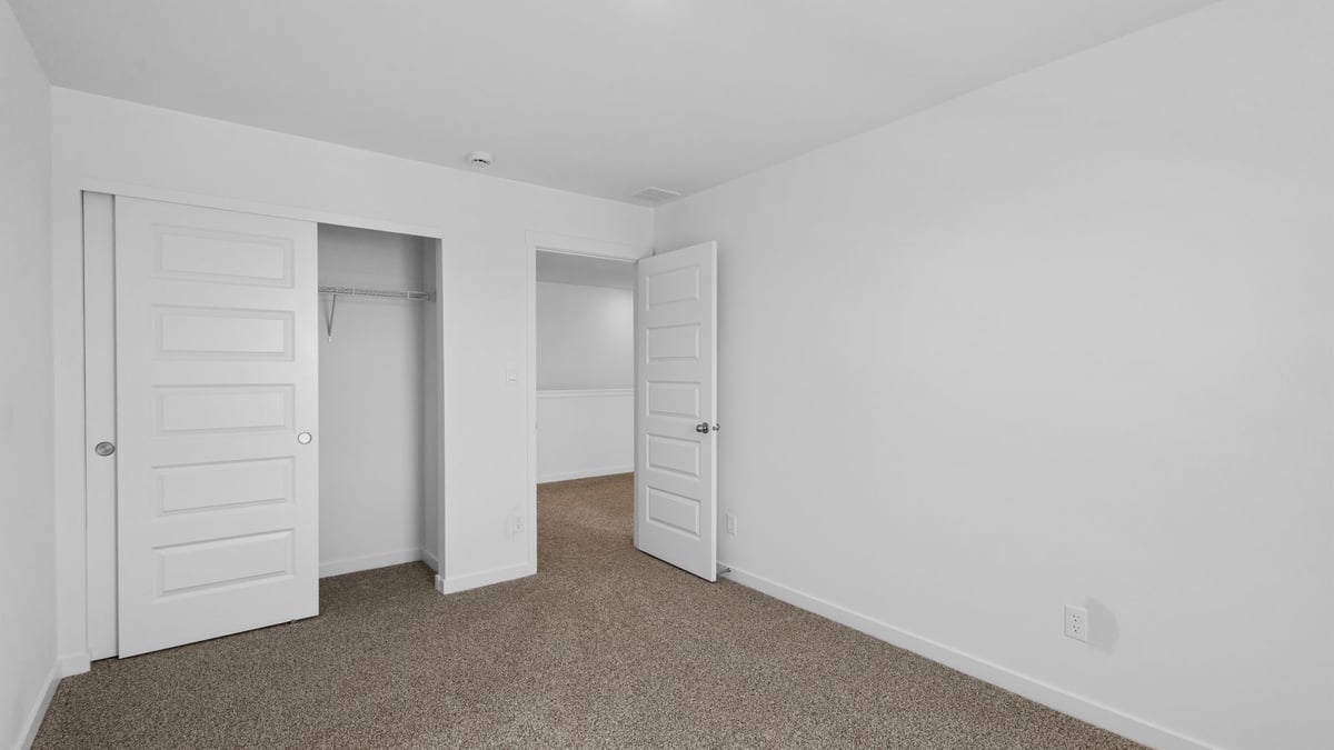 Bedroom with carpet and closet.