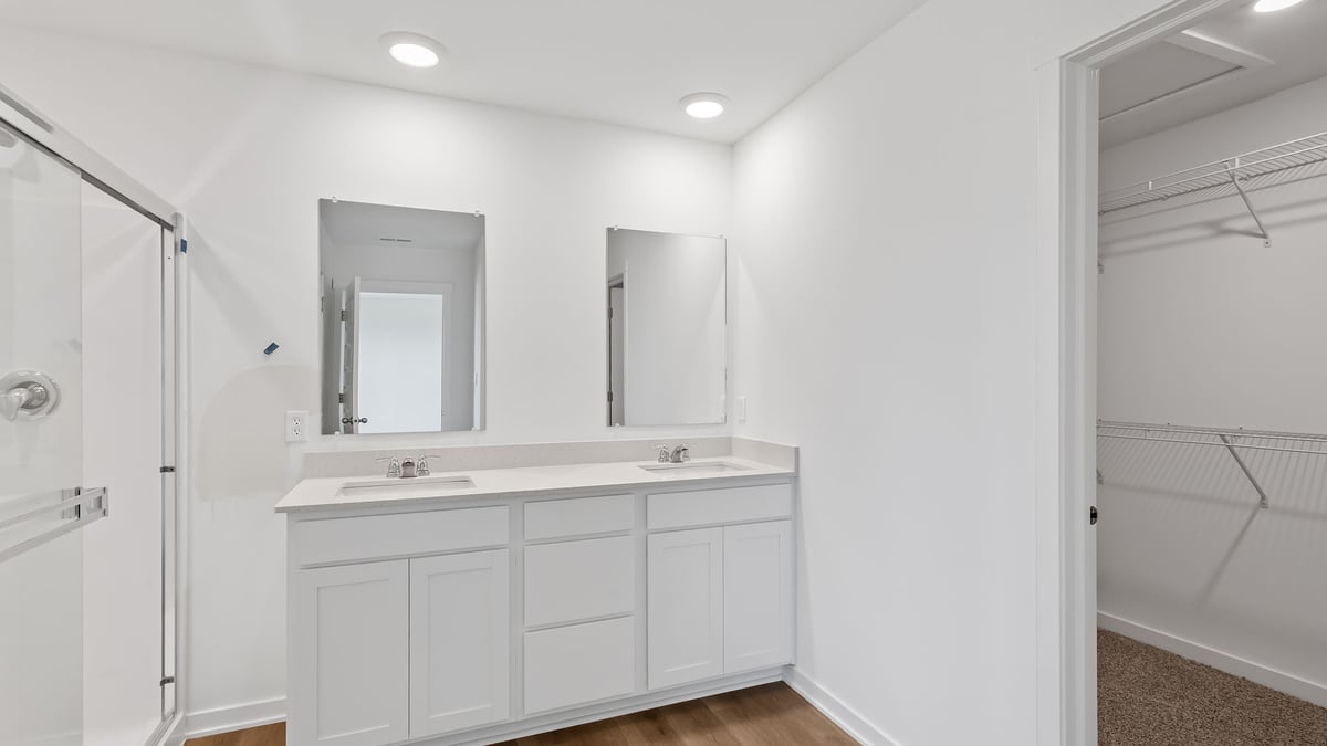 Dual vanity sinks walk in shower.