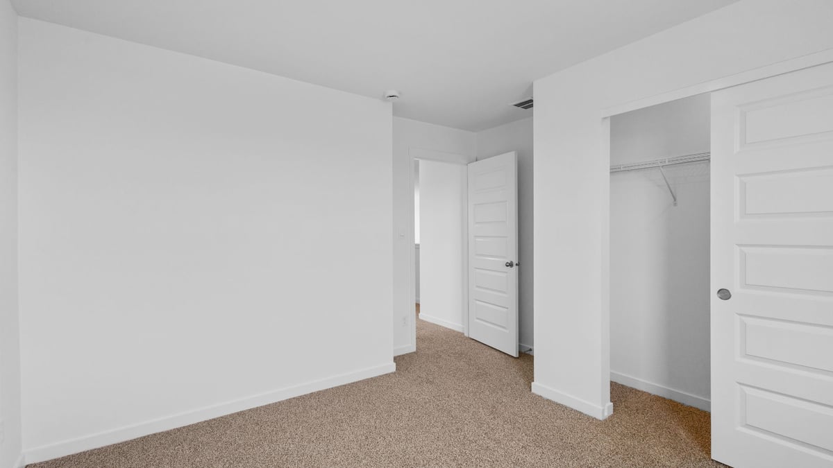 Bedroom with carpet and closet.