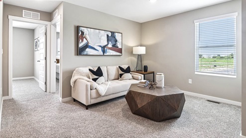 Loft area with carpeted floors and a window.