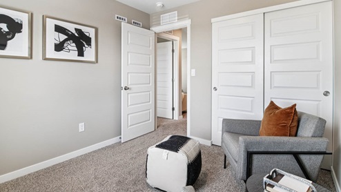 Bedroom with carpeted floors and a window.