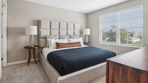Bedroom with carpeted floors and a window.
