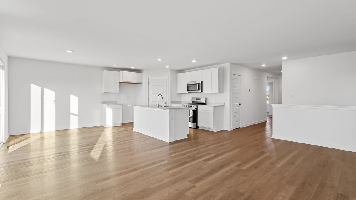 Living area with a view of dining area and kitchen area.