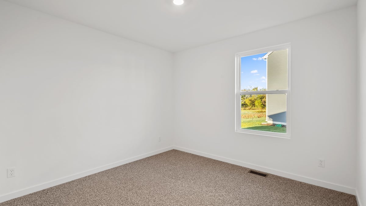 Bedroom with a carpet and a window.