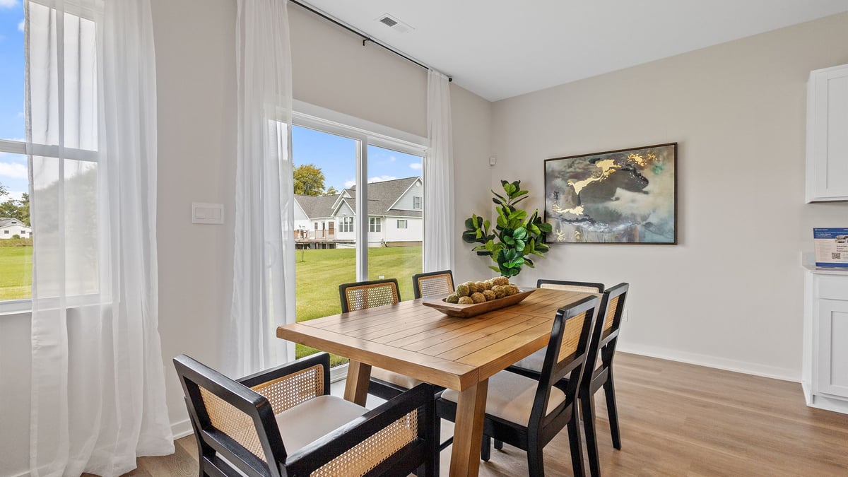 Dining area with a side window and glass sliding door.