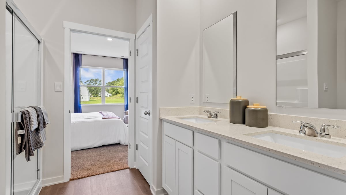 Dual vanity sinks with a walk-in shower.
