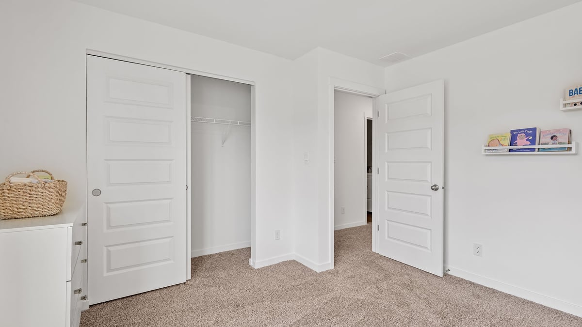 Bedroom with carpeted floors and a closet.