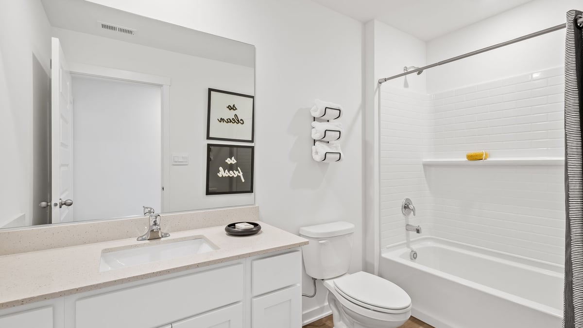Bathroom with one vanity sink and bathtub.