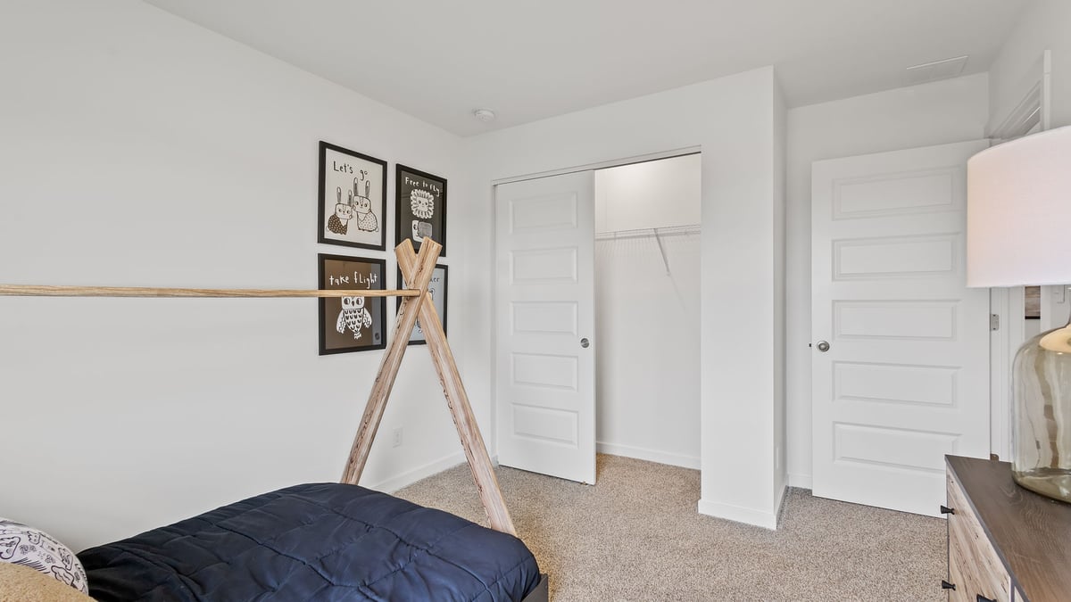 Bedroom with a closet and carpeted floors.