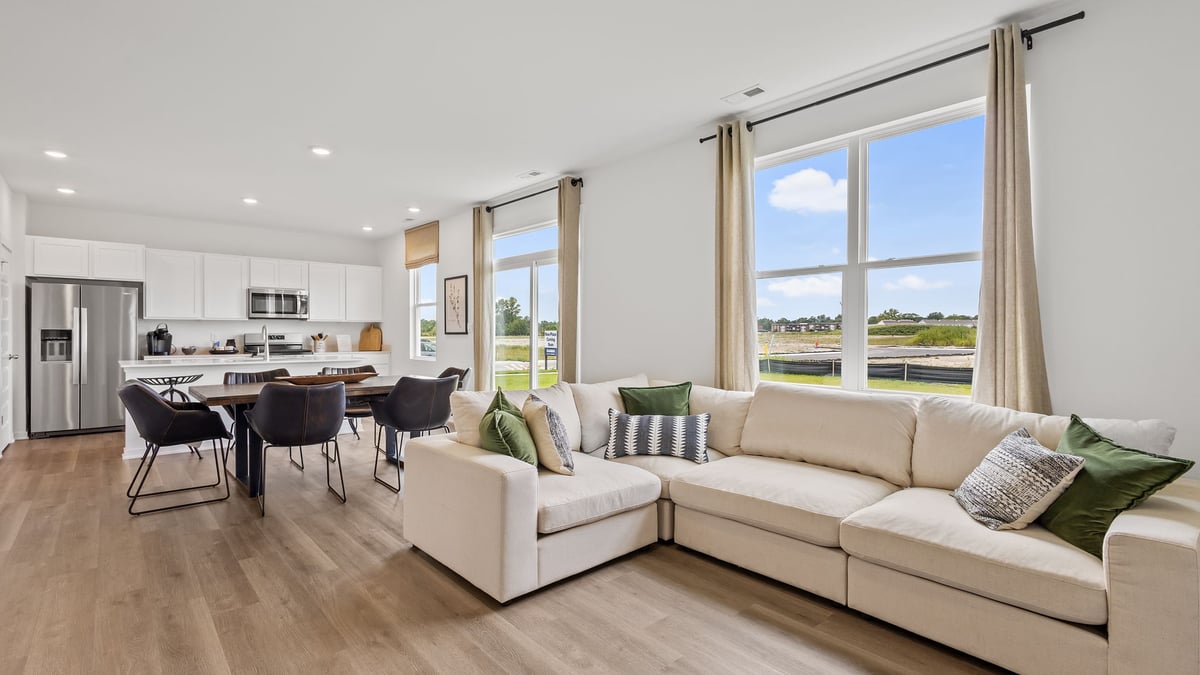 Spacious living area with large windows.