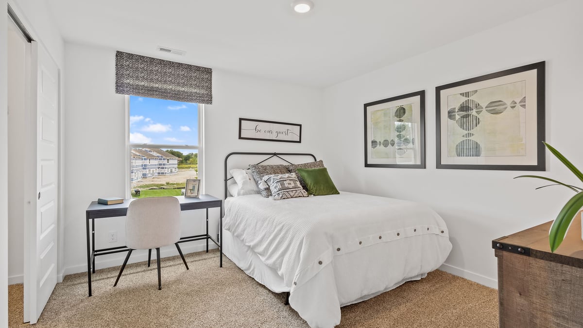 Bedroom with carpet and a window.