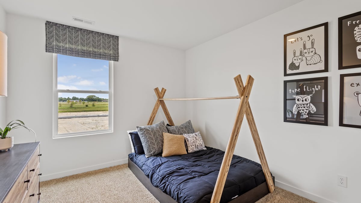 Bedroom with carpet and a window.