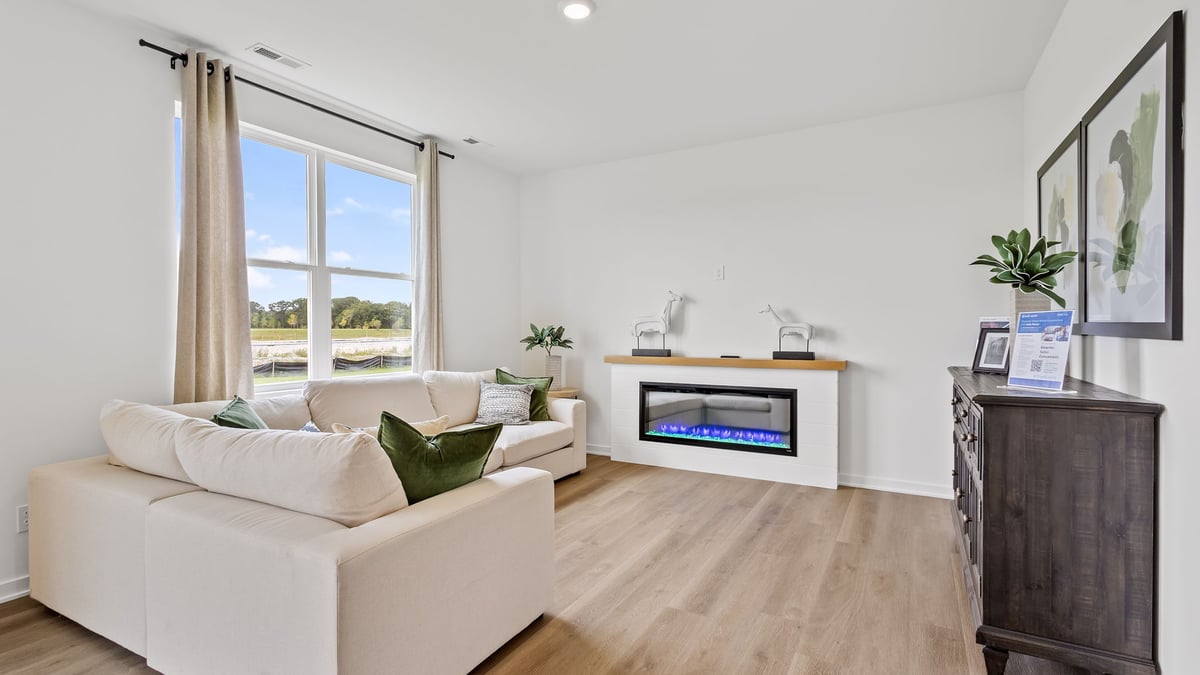 Living area with hard wood floors and a big window.