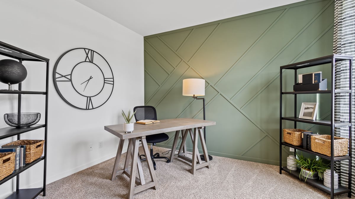 Front room with carpet made into an office space.