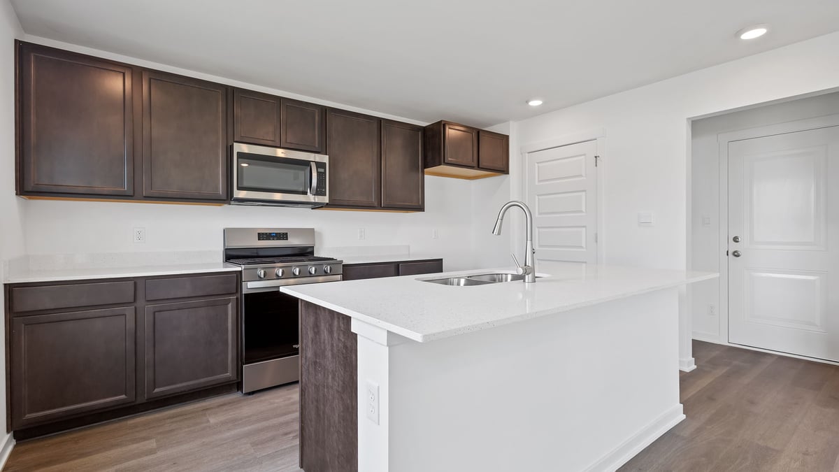 Kitchen with flagstone cabinetry and quartz countertops.