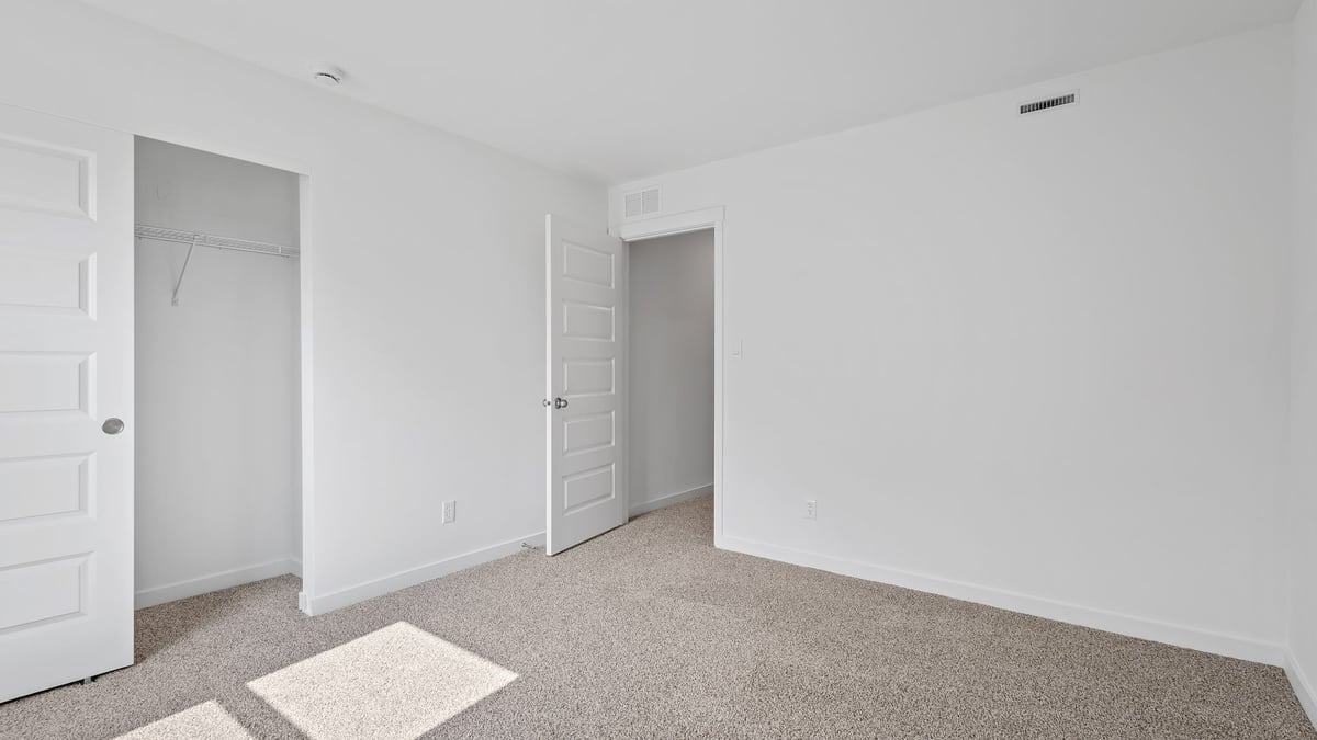 bedroom with a closet and carpeted floors.